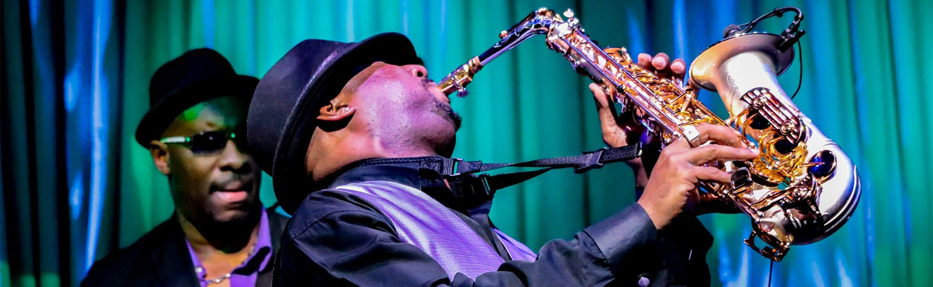 men on stage with sax