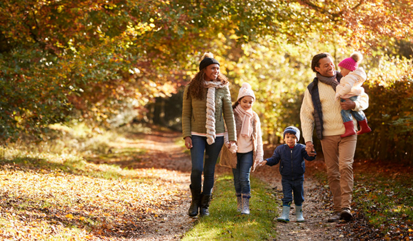 family hiking through fall path