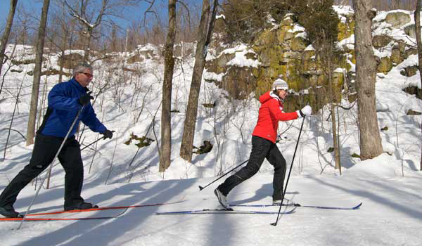 man and woman cross country skiing