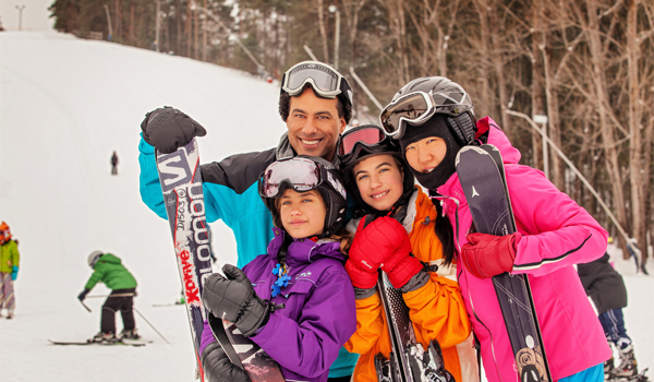 family playing in the snow