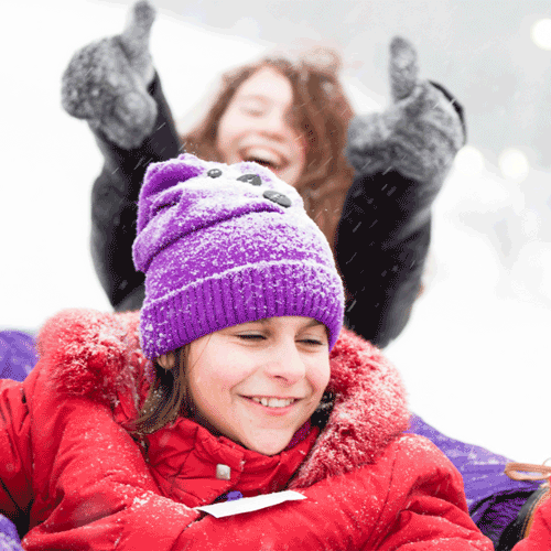 Two kids playing in the snow