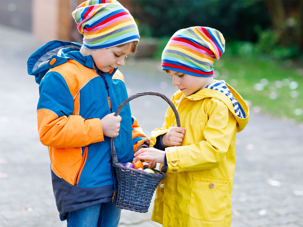 Two boys holding a basket with easter eggs