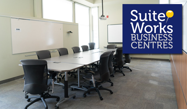 Suiteworks Barrie meeting room with board table and chairs, including Suiteworks logo in top right corner