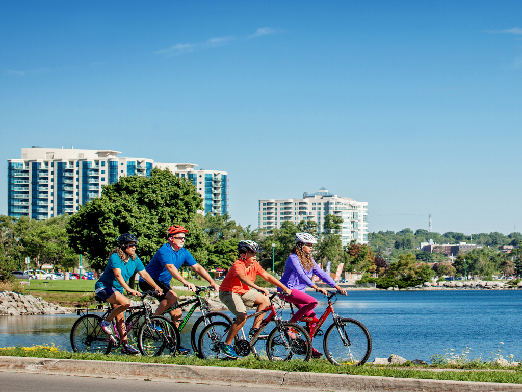 A group biking in front of a lake