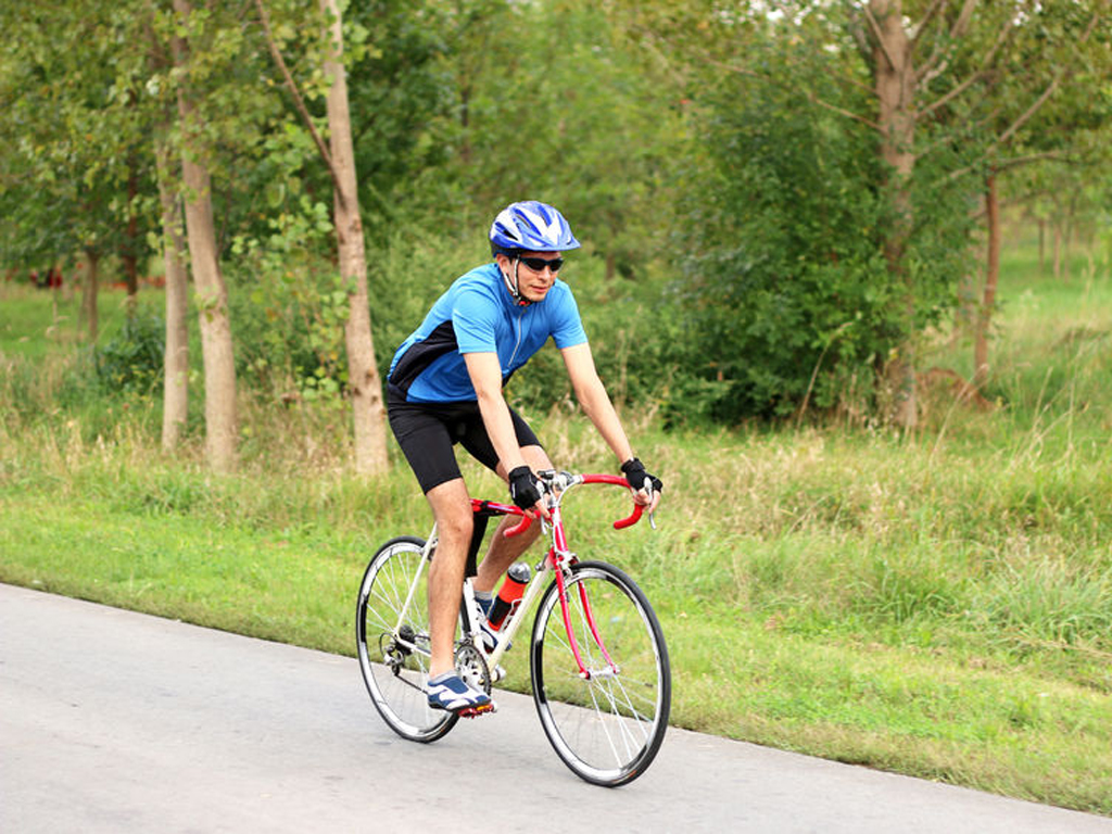 man biking on the road