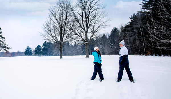 friends snowshoeing in a park