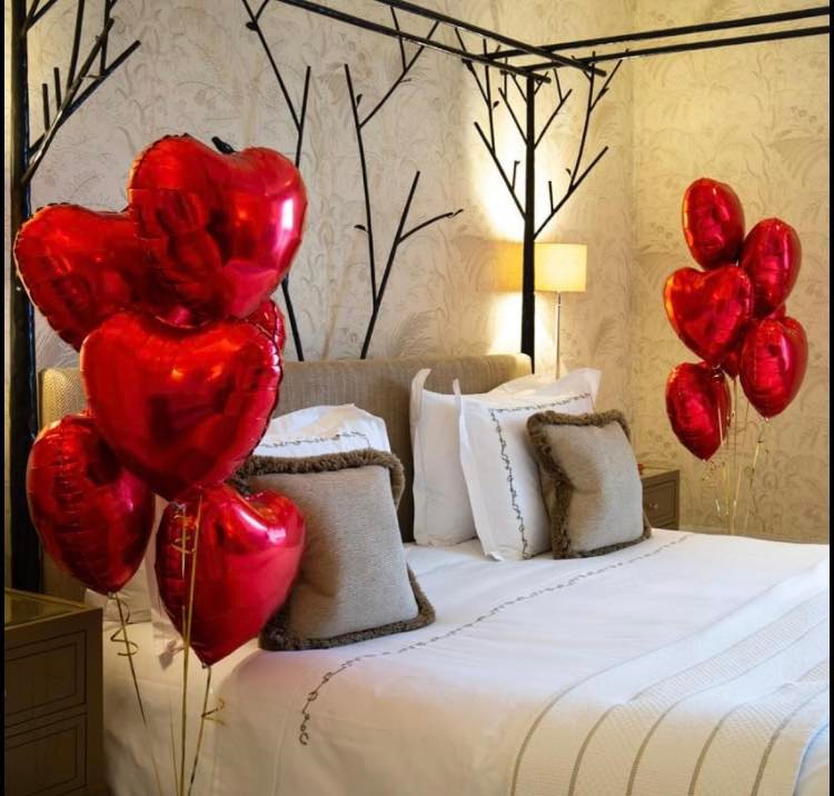 Heart Balloon bouquets next to bed 