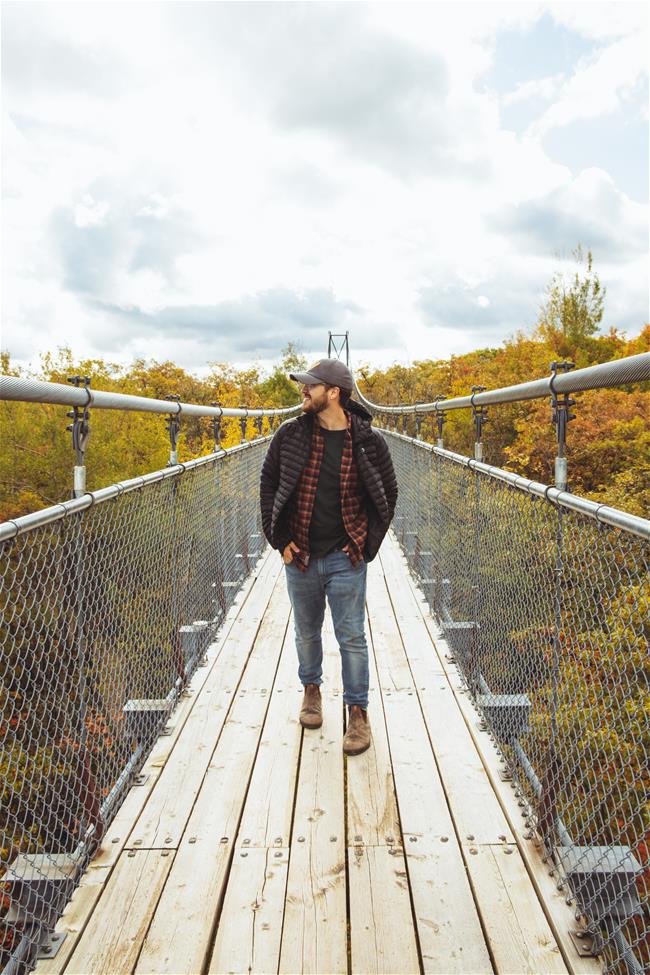 man on suspension bridge