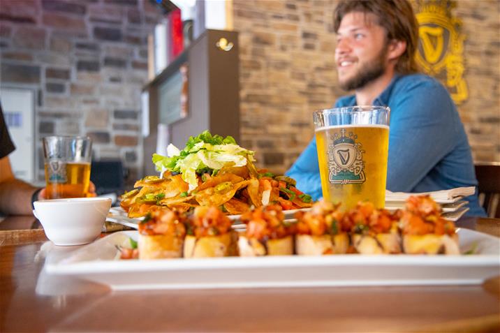 LAF_8613 beer and food on table with man in background