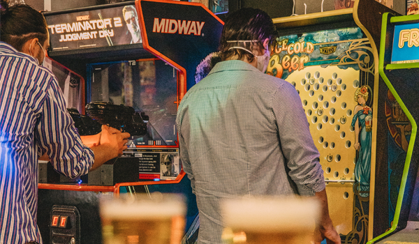 people playing arcade games