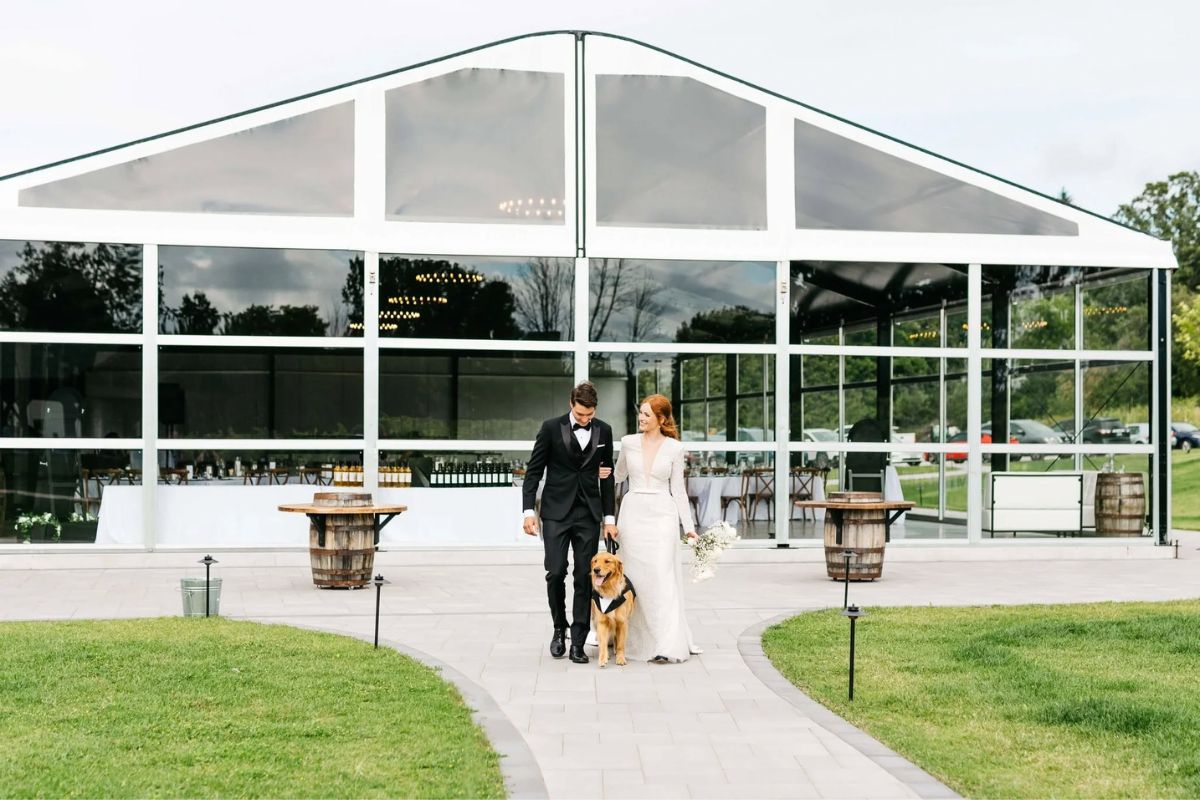 Bride and groom walking on path new event space at Heritage Estates