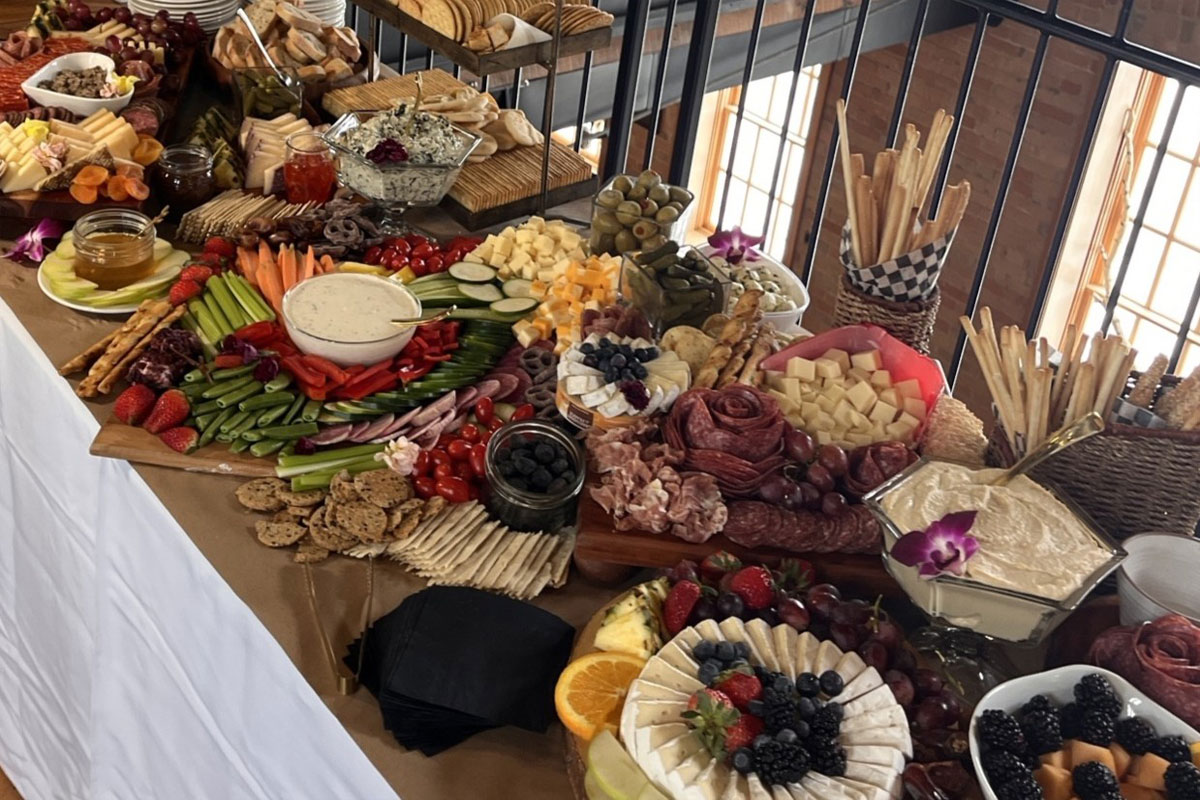 Spread of food items on table available to order through KAJO Catering