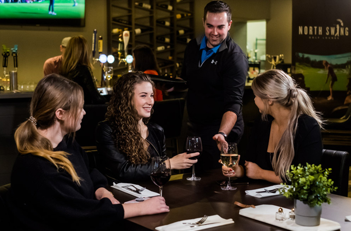 Friends enjoying some drinks at North Swing Golf Lounge in Barrie