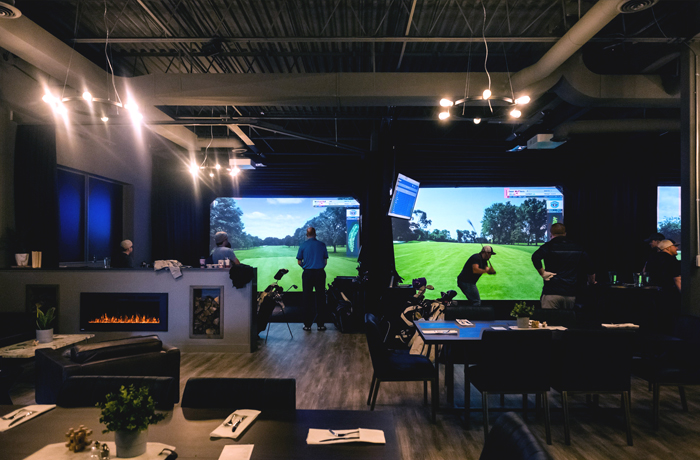Inside view of North Swing Golf Lounge in Barrie featuring two virtual ranges