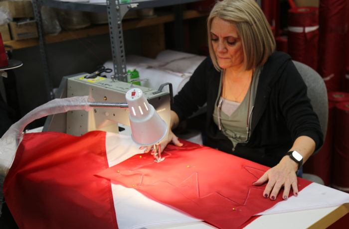 woman sewing canada flag